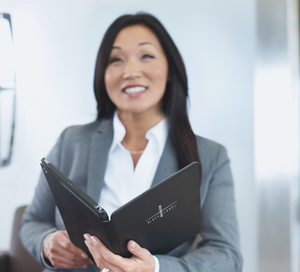 Sales associate and customers reviewing plan details on a tablet